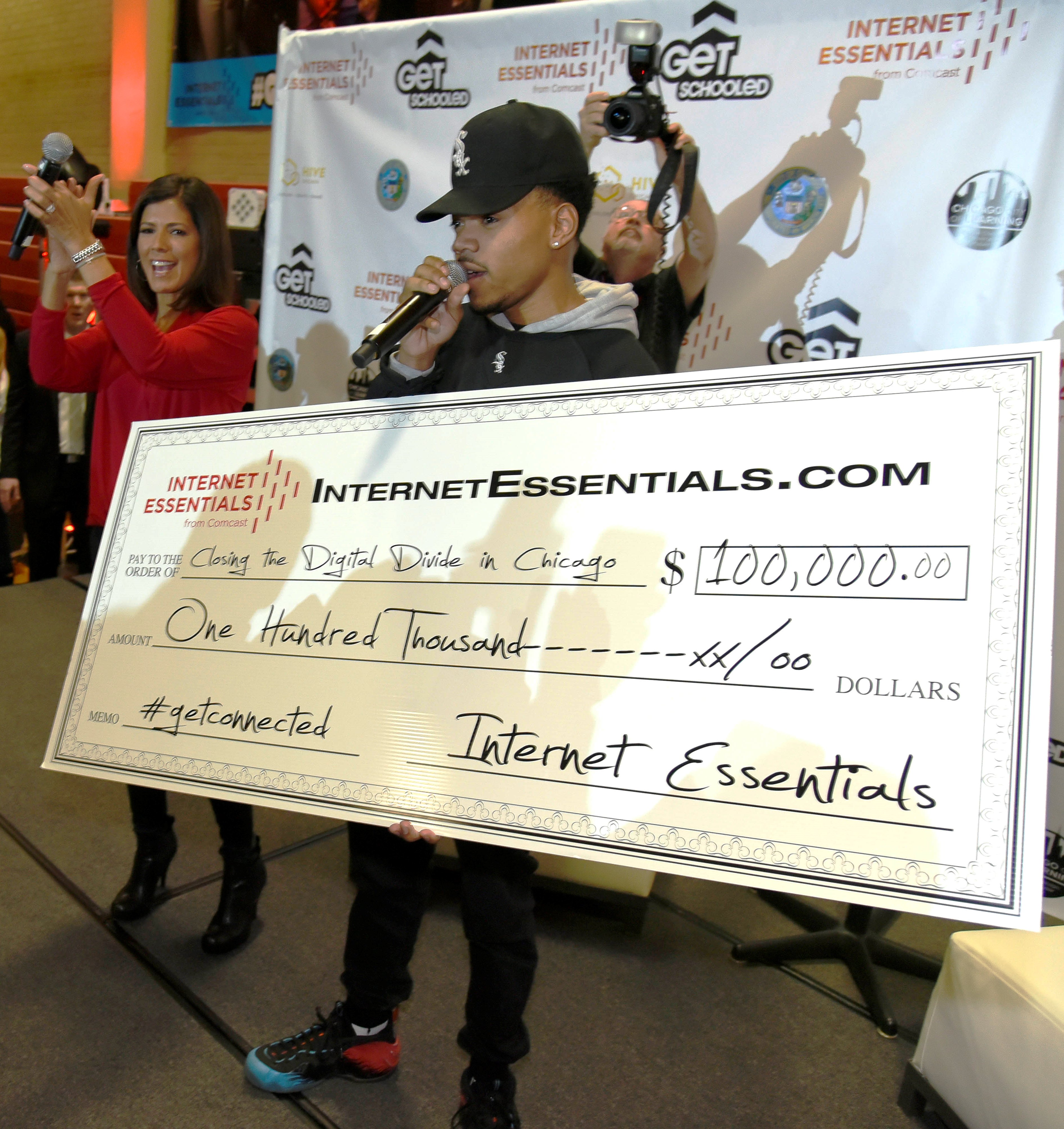Chance the Rapper makes a $100,000 check presentation to six Chicago Public Schools and six community-based organizations apart of the Get Schooled, Get Connected Celebration.