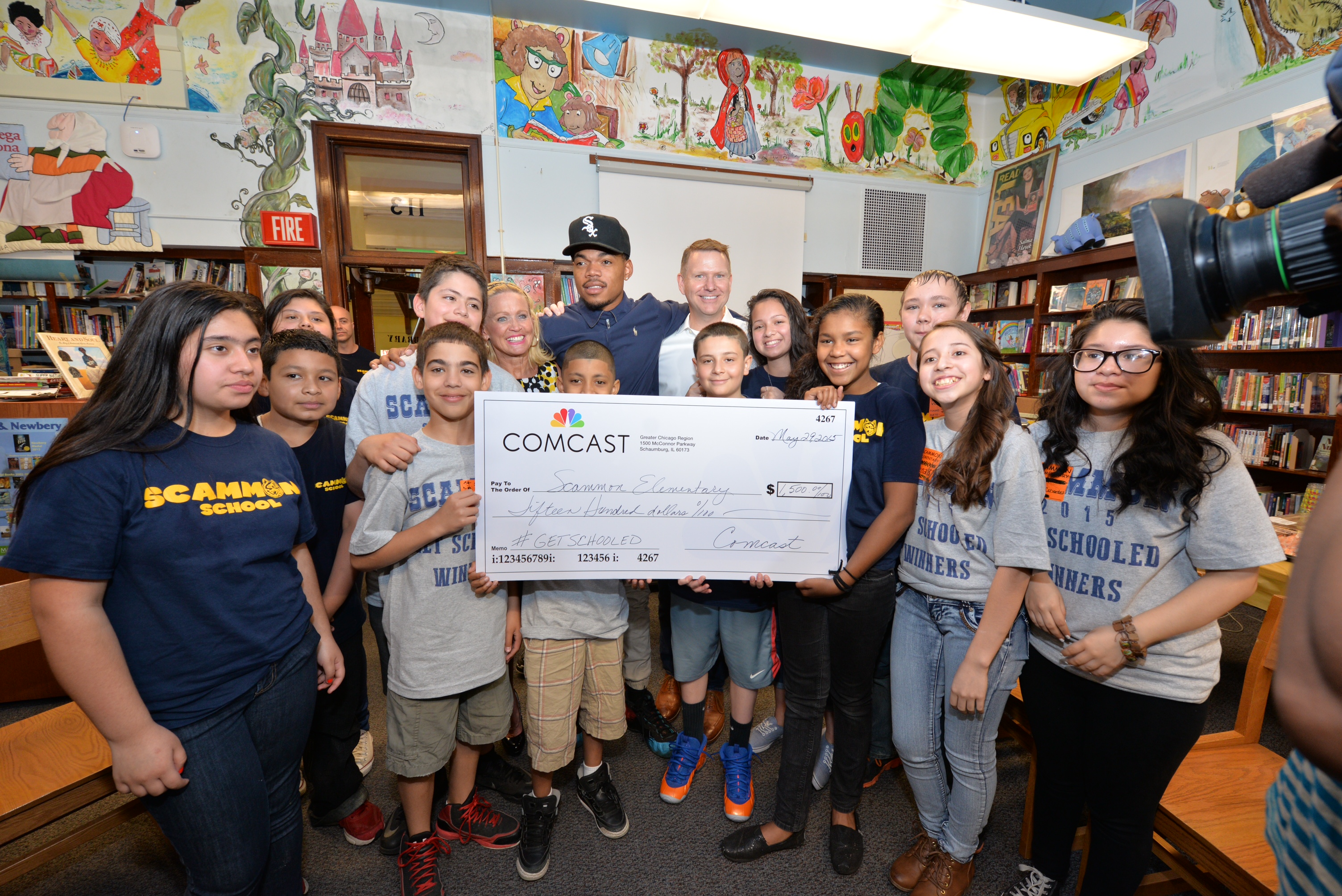 Chance the Rapper joins Comcast's Joe Higgins to recognize Chicago's Scammon Elementary for tying for first place in the "Get Schooled, Get Connected" Spring Challenge.