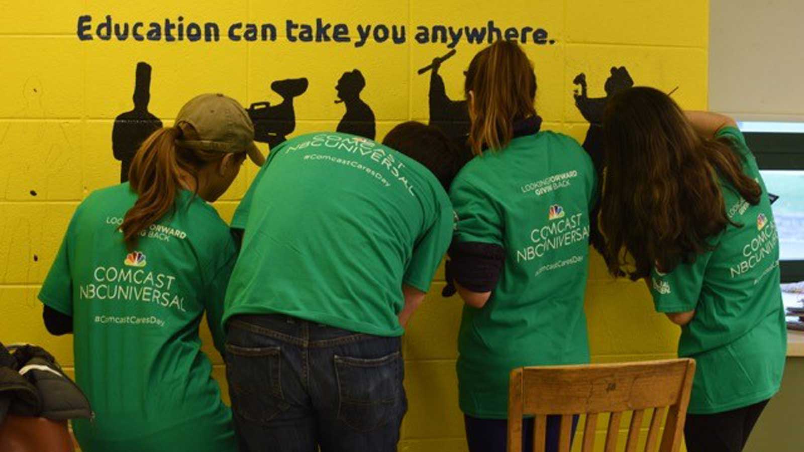 Comcast Cares Day volunteers painting mural
