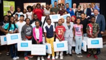A group of children receive Internet Essentials laptops at an event in Chicago.