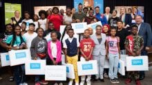 A group of children receive Internet Essentials laptops at an event in Chicago.