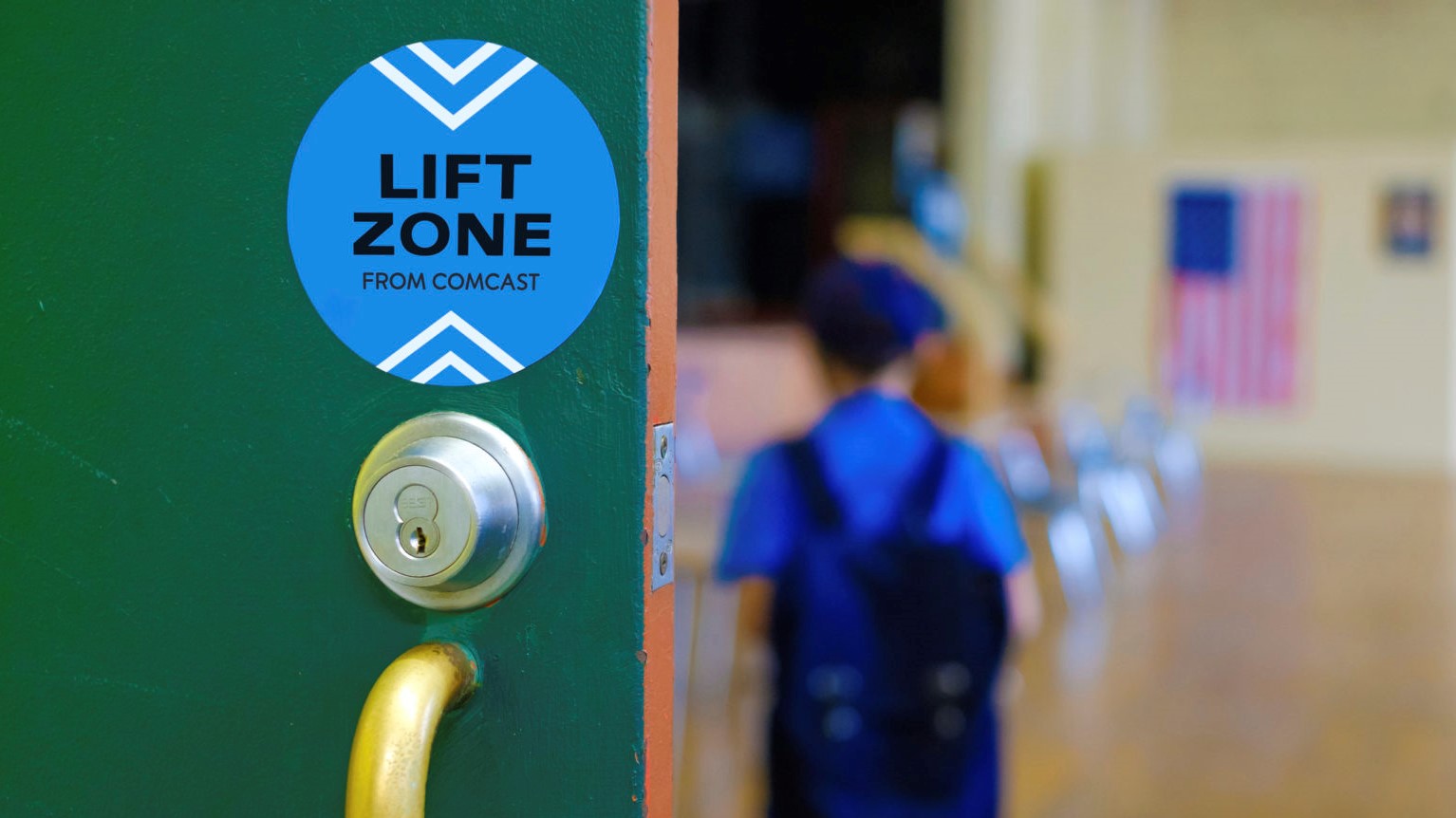A Lift Zone sticker on a community center door