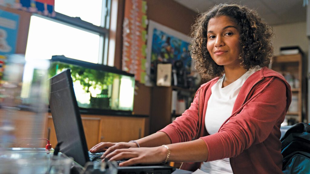 Young student on her laptop connected online through Xfinity's fast and reliable  internet services courtesy of Comcast.