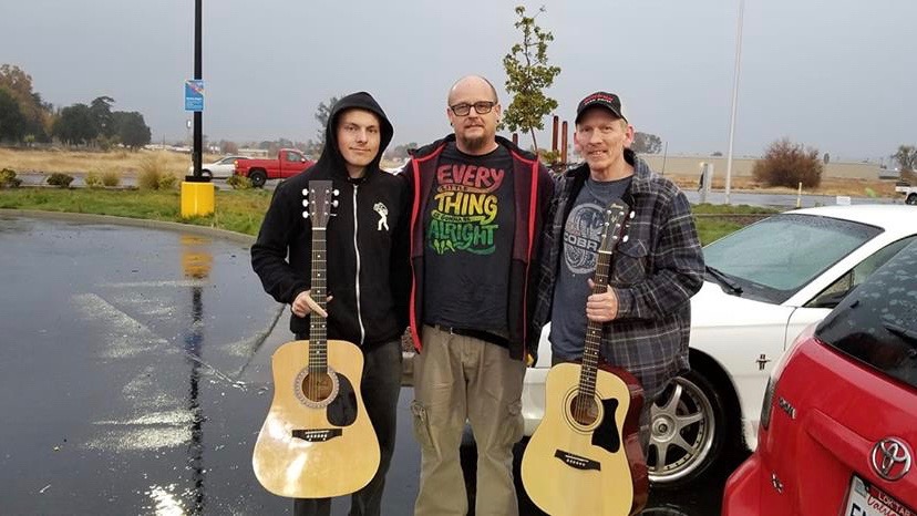 three men and two guitars