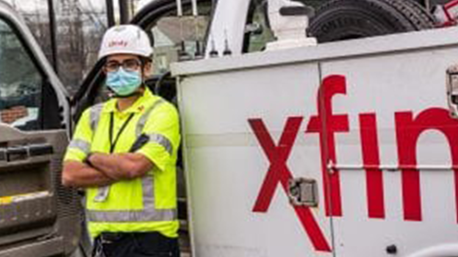 An employee standing in front of an Xfinity truck.