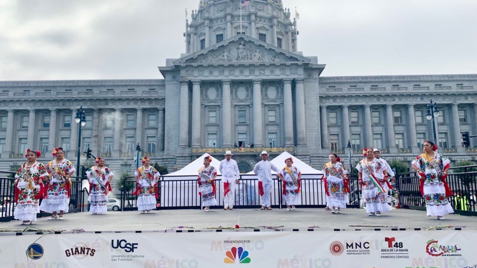 Dancers performing on stage in front of San Francisco City Hall