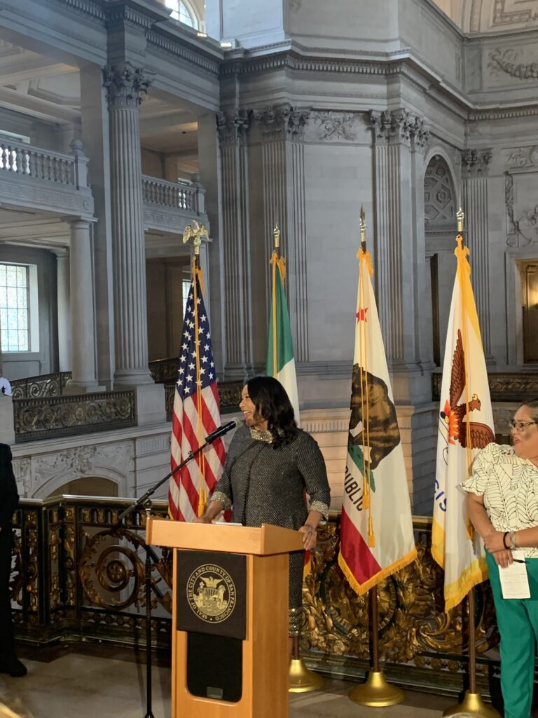 Mayor London Breed speaks at a podium at San Francisco City Hall for El Grito de Independencia 2023