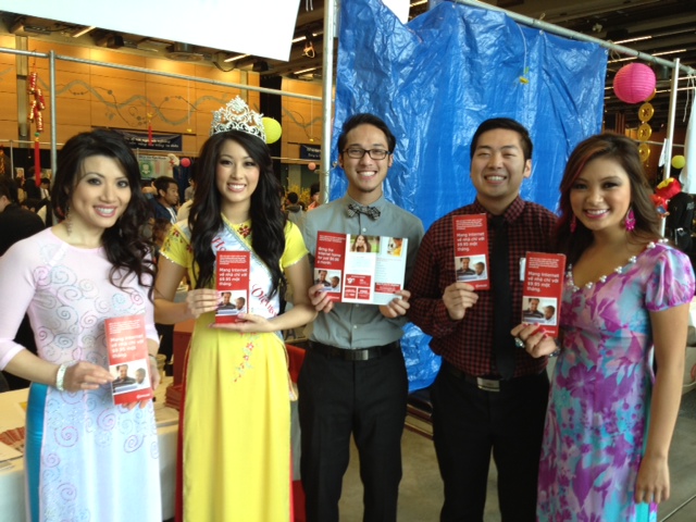 Vietnamese Lunar New Year festival coordinators hold up Internet Essentials brochures on Feb. 16 at the Seattle Center. From left to right: Samantha Hoang (Executive Director of Miss Vietnam Washington), Lynda Pham (Miss Vietnam Washington 2013), Elson Tran (Tet in Seattle volunteer), Joe Nguyen (Tet in Seattle volunteer), and Verlinda Vu (Tet in Seattle Public Relations). 
