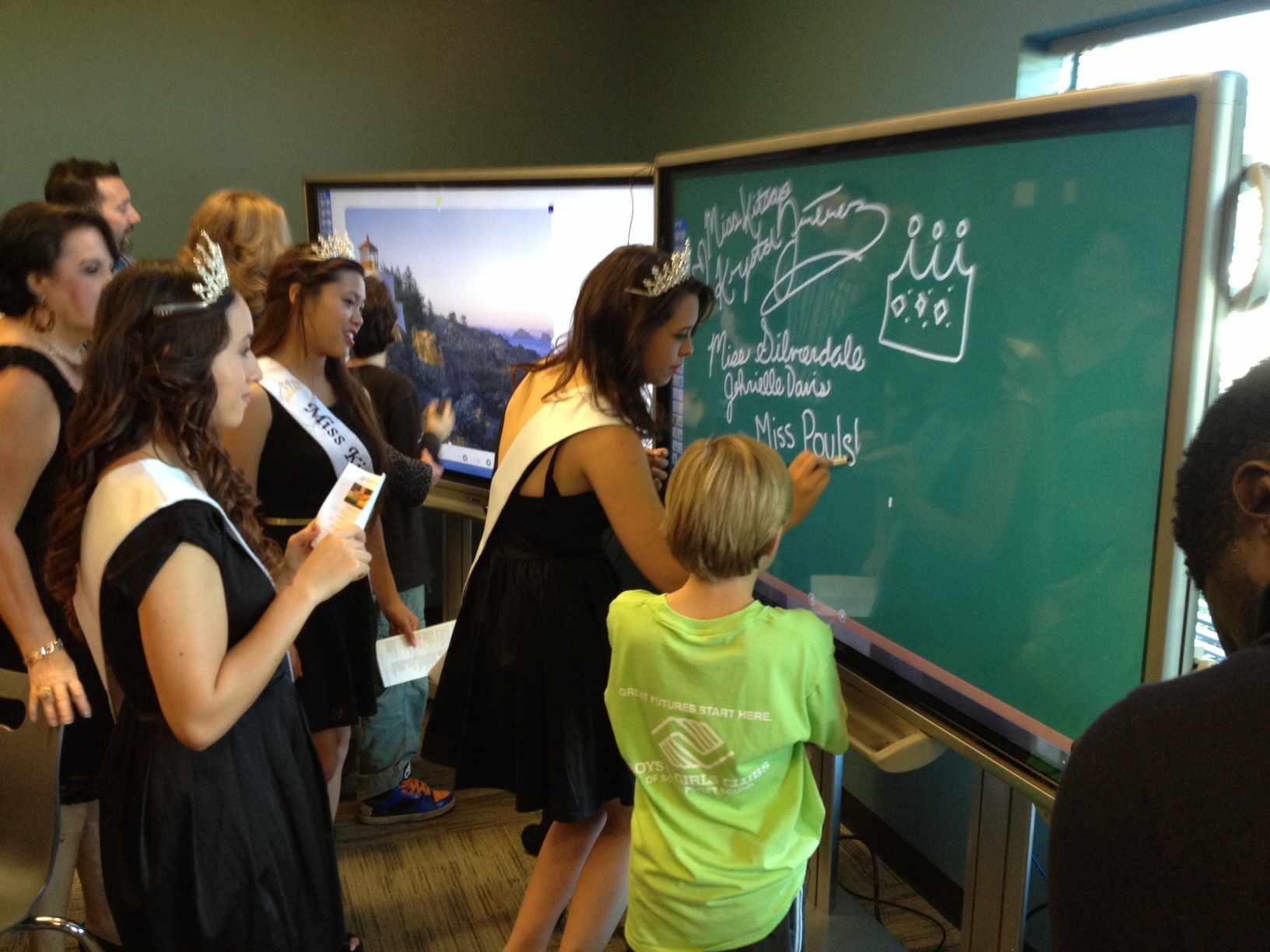 teens using smart board as a chalkboard