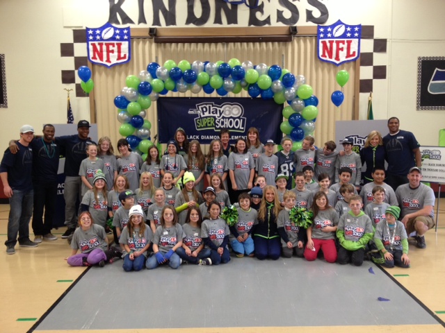 students posting with Seahawks at the event