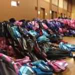Photo of dozens of backpacks