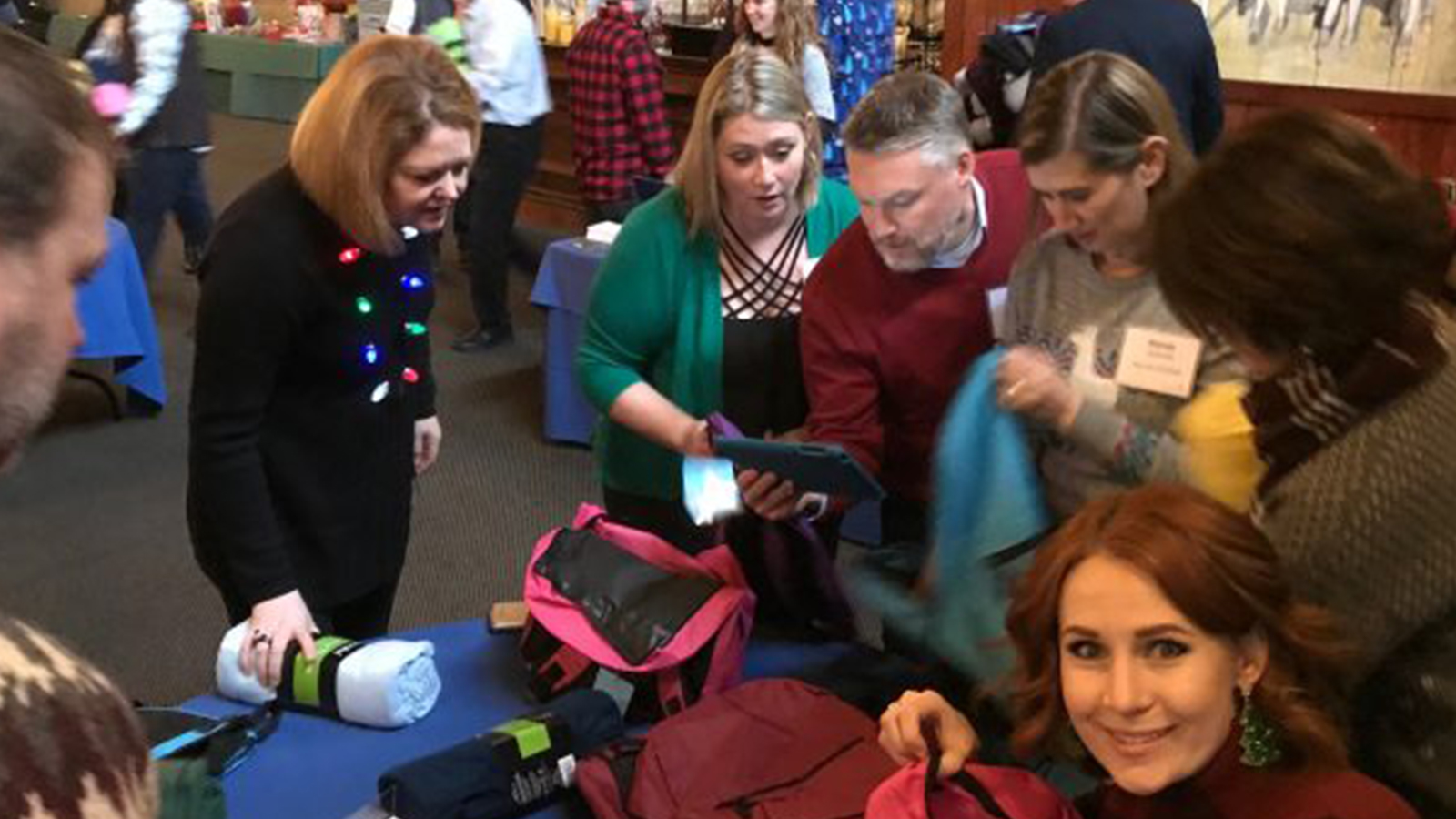 Volunteers fill backpacks for Helping the Homeless.