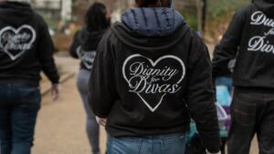 A photo of women from behind wearing Dignity for Divas jackets.