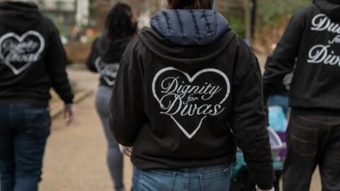 A photo of women from behind wearing Dignity for Divas jackets.