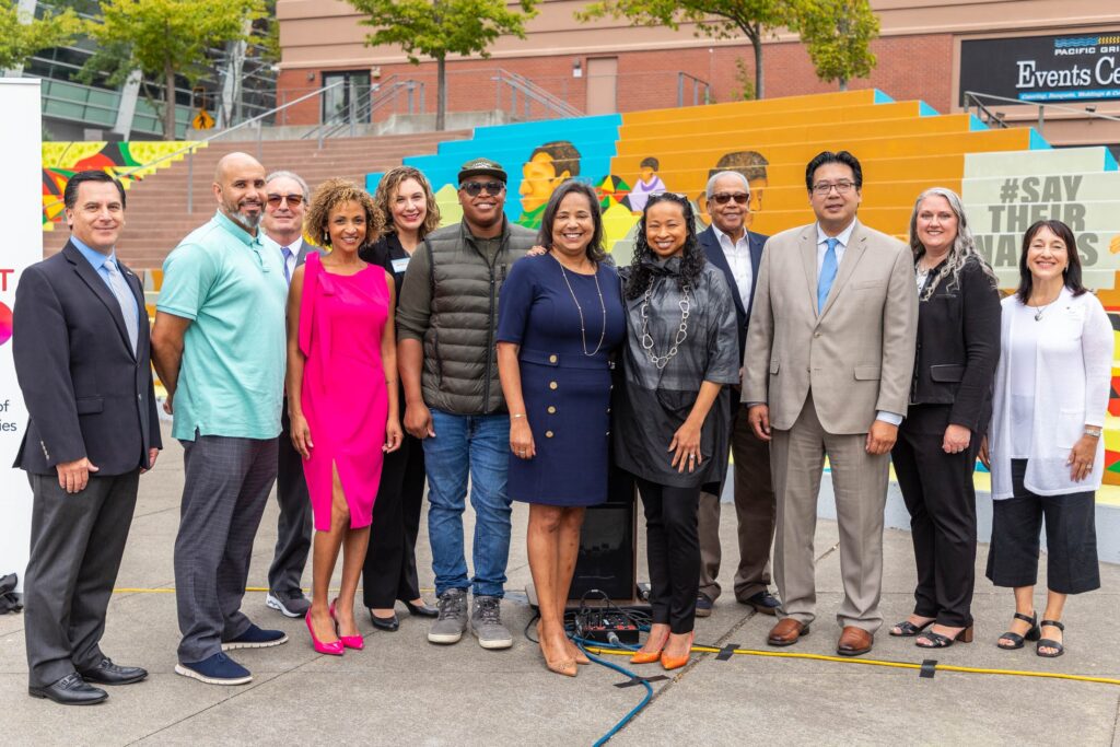 Comcast and Tacoma city leaders pose in Tollefson Square.