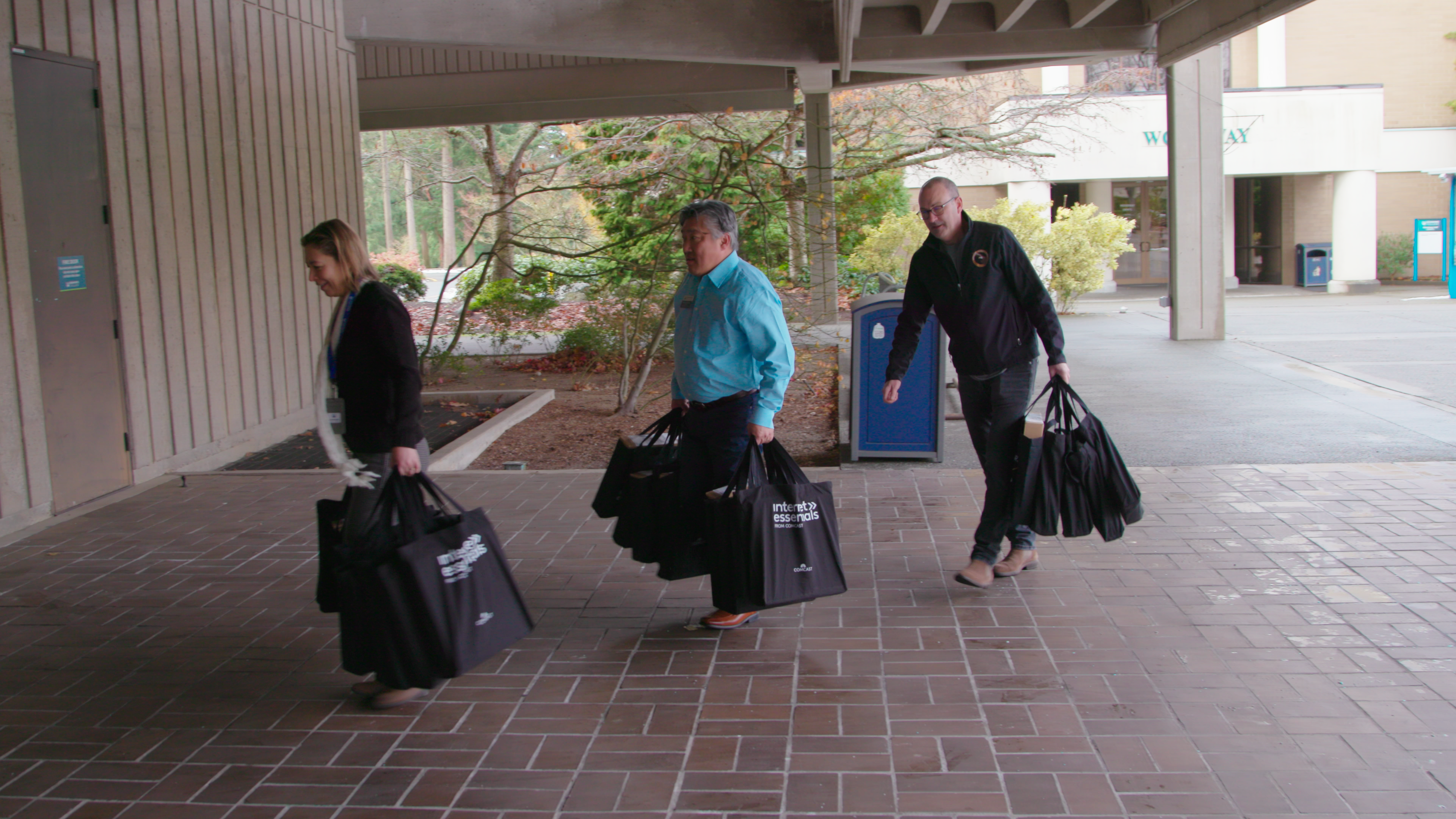 Edmonds College and Operation Military Family's Mike Schindler bring in Comcast donated laptops. 