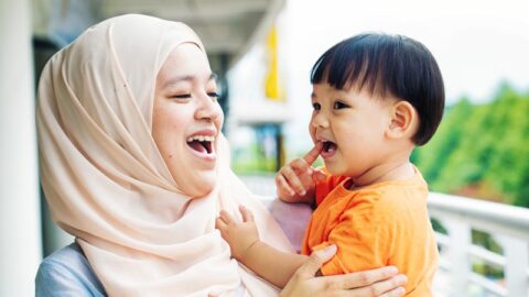 A woman works with a young child.
