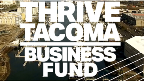 Thrive Tacoma Business Fund written over downtown Tacoma.