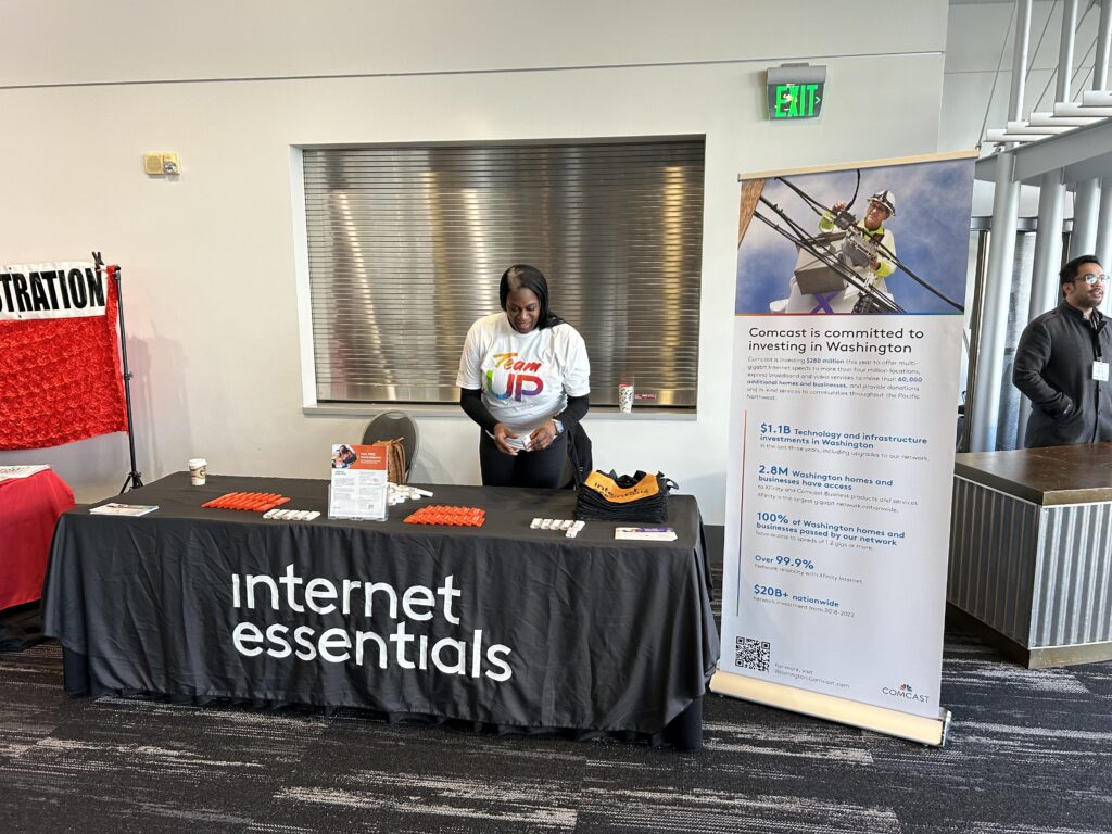 A Comcast employee at a Comcast Internet Essentials booth. 