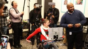 A young woman uses eye control functions on a tablet.
