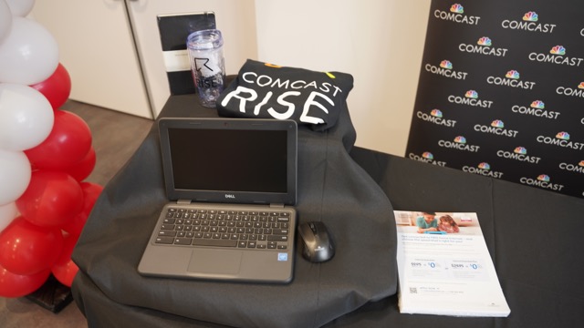 Laptop and Comcast Rise bag sitting on a table