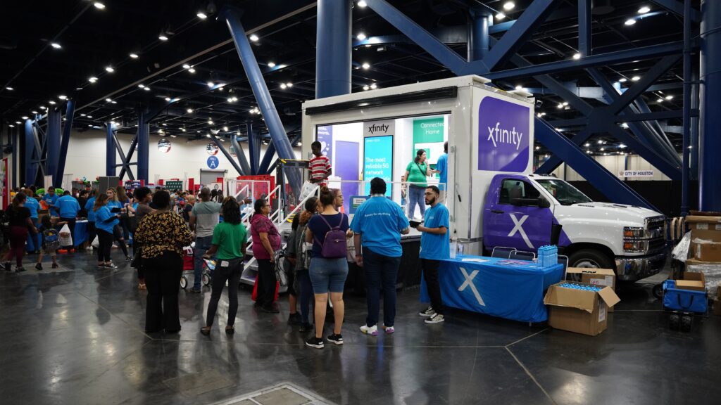 Attendees engaging with a mobile Internet Essentials truck