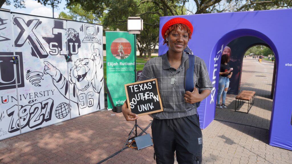 Young woman wearing red beret holding Texas Southern Univ sign