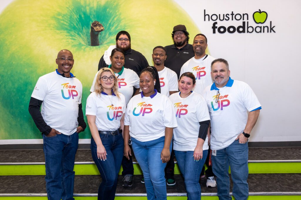 Group of Team Up volunteers posing for picture at Houston food bank.