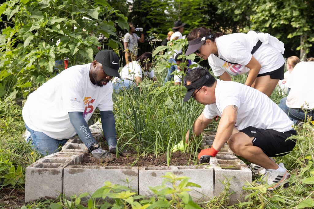 Volunteers pull weeds at the Blodgett Urban Garden in Houston, Texas.