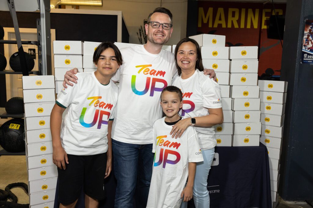 Family wearing Team Up t-shirts posing for a picture