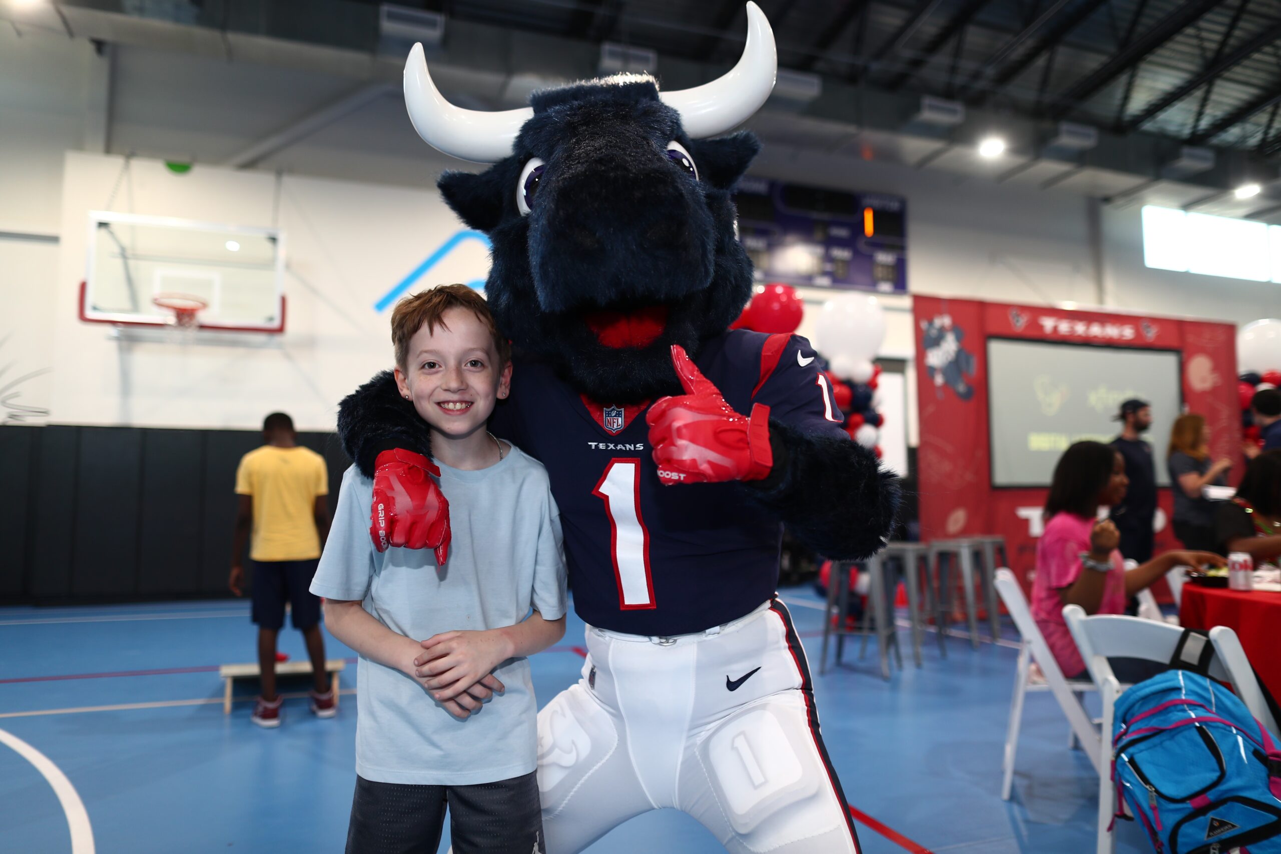 Young boy posing with mascot
