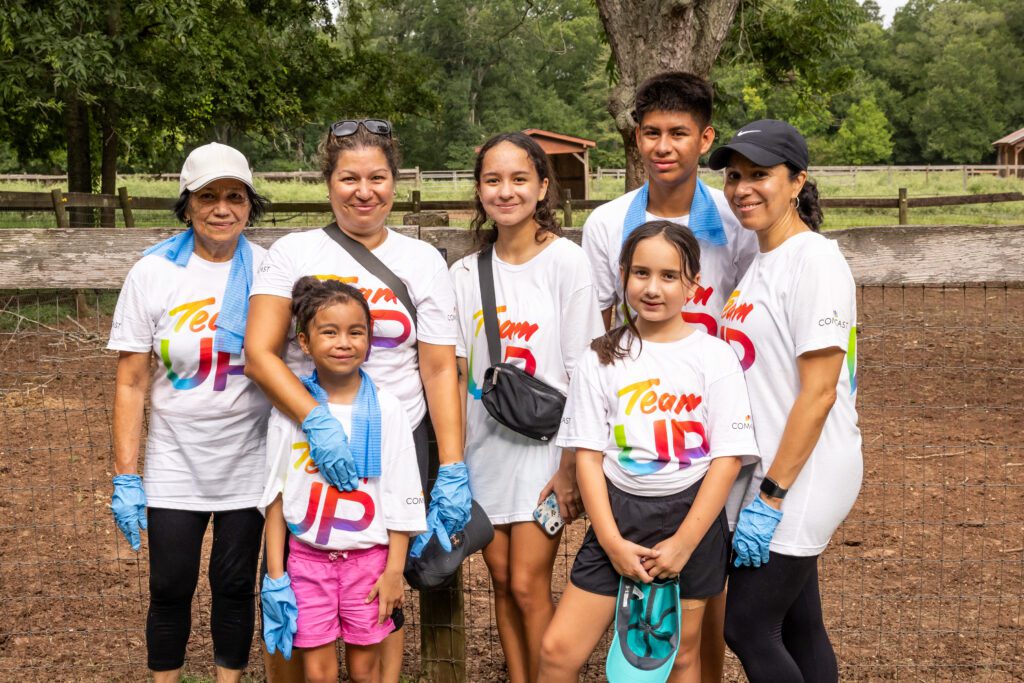 Family wearing Team Up t-shirts pose for picture