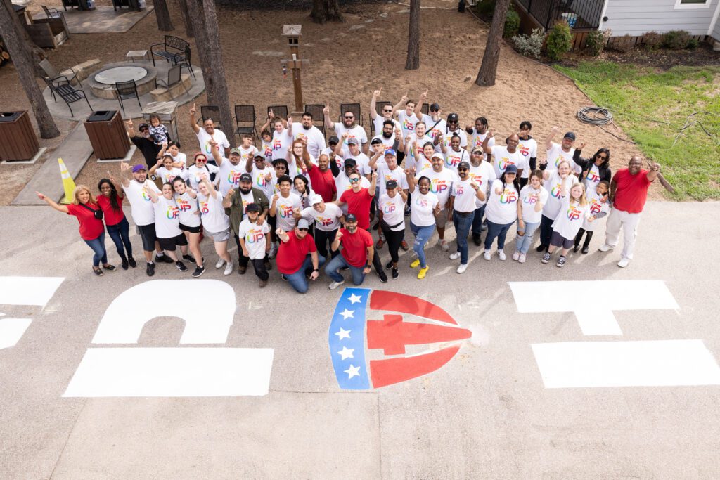 Volunteers gather for a group photo at a Team UP event at Camp Hope in Houston, Texas.