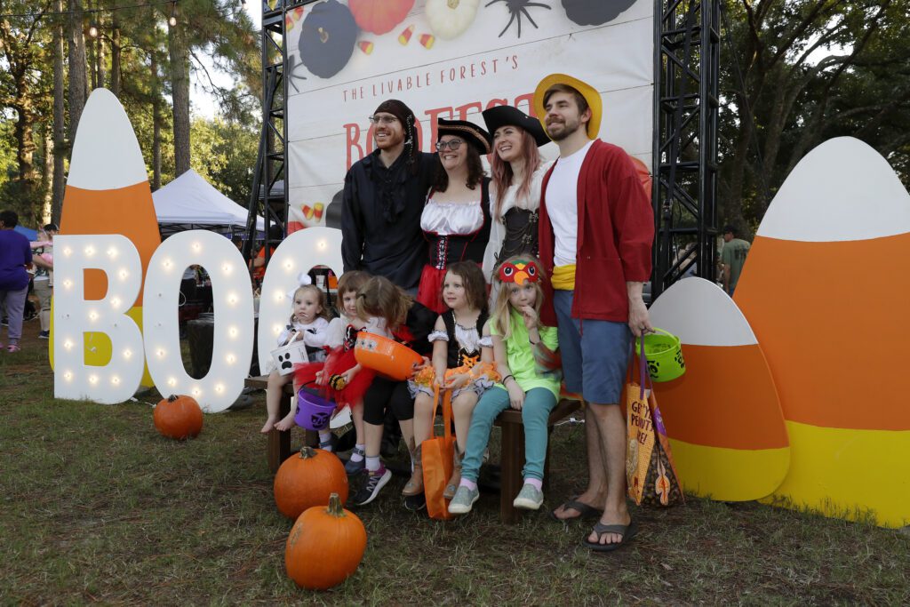 Attendees take photos in front of the Boofest sign at the pumpkin patch during the Comcast Kingwood Takeover, held at the Kingwood Town Center Park on Saturday, Oct. 28, 2023 in Kingwood, TX. (Michael Wyke/AP Images for Comcast)