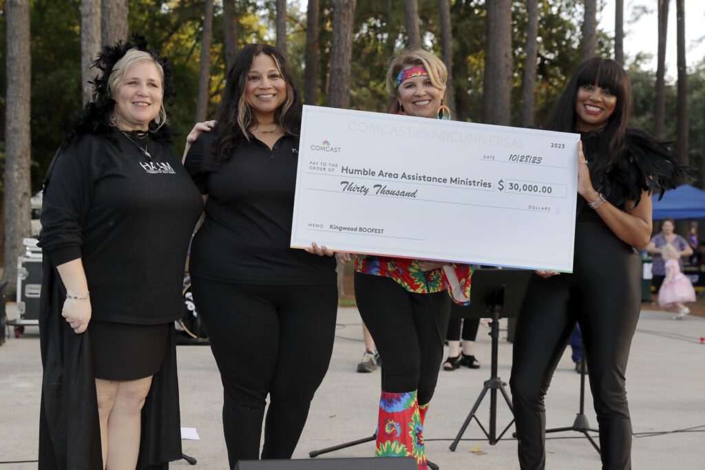 Check presentation ceremonies to beneficiaries by Comcast staff on the stage during the Comcast Kingwood Takeover, held at the Kingwood Town Center Park on Saturday, Oct. 28, 2023 in Kingwood, TX. (Michael Wyke/AP Images for Comcast)