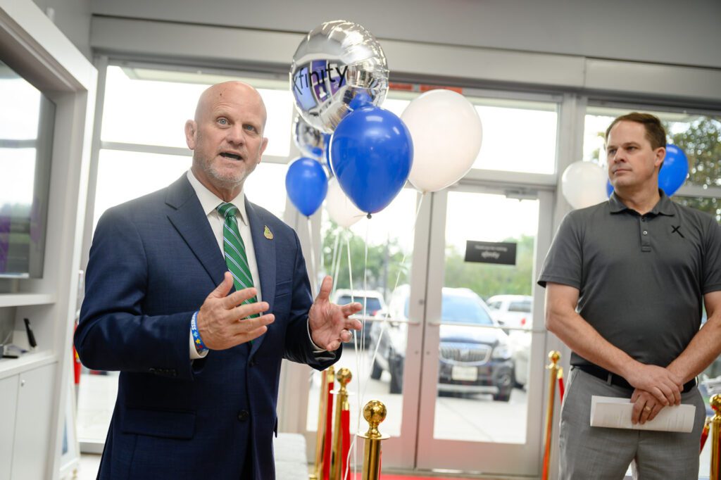 Pearland Mayor Kevin Cole speaks at an Xfinity store.