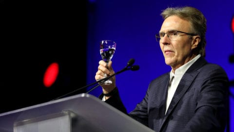 Tony Werner, president of Technology, Product, Xperience for Comcast, speaking onstage at a podium.