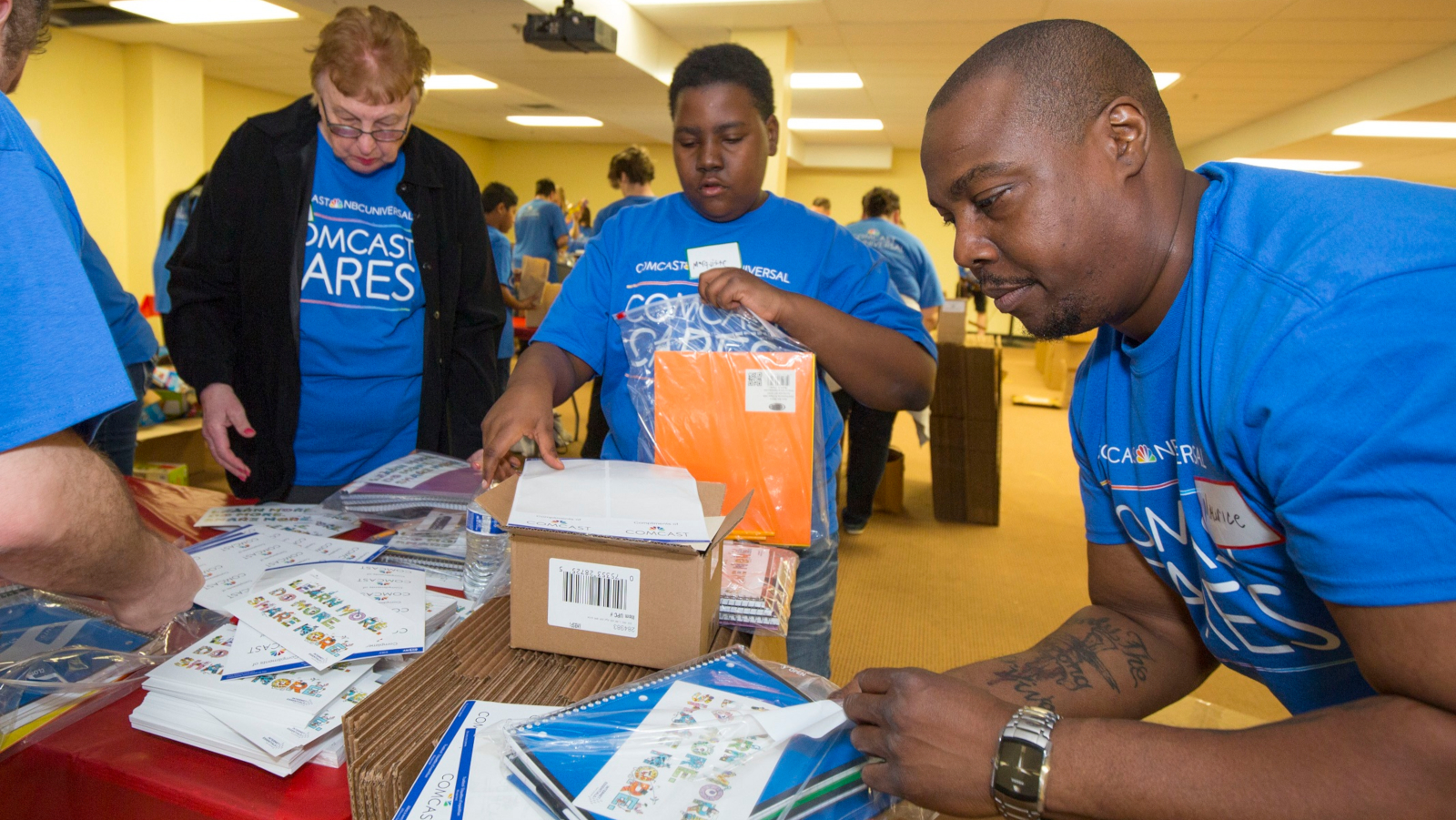 Comcast Cares Day volunteers pack homework kits for young students.