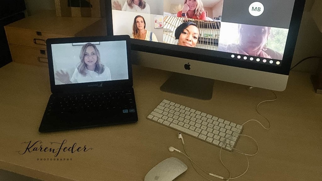 A laptop displays a video conference call