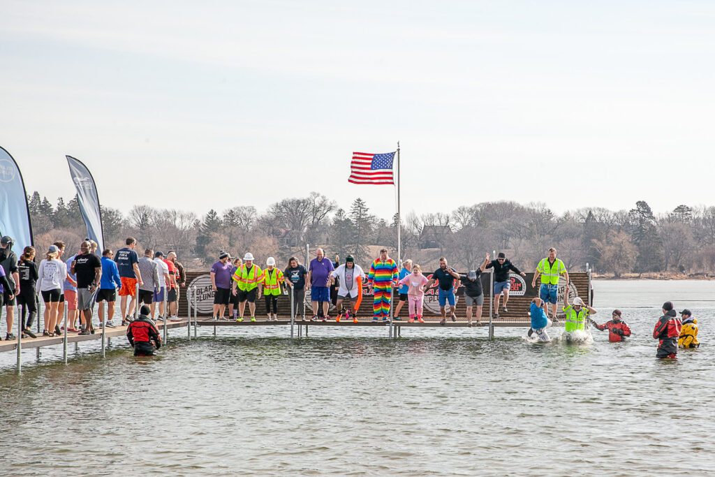 Comcast Midwest Polar Plunge participants stand on the dock right before they jump.