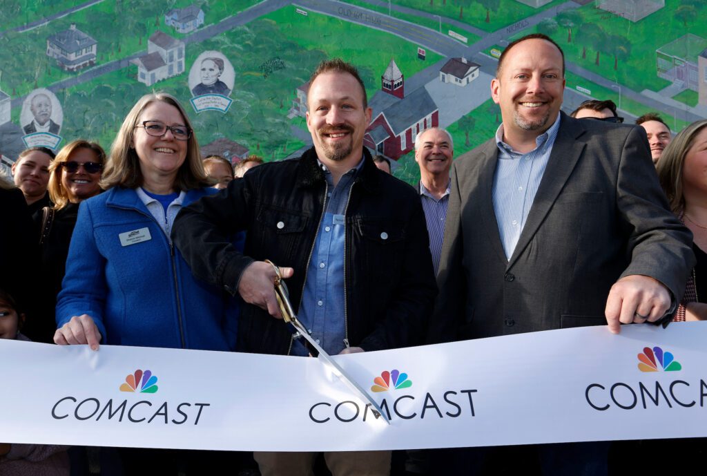 Sharon Mitchell of Spring Hill Chamber of Commerce, Mayor Joe Berkey of Spring HIll and Jay Gottman, Director of Sales and Marketing for Comcast, get ready to cut the ribbon.