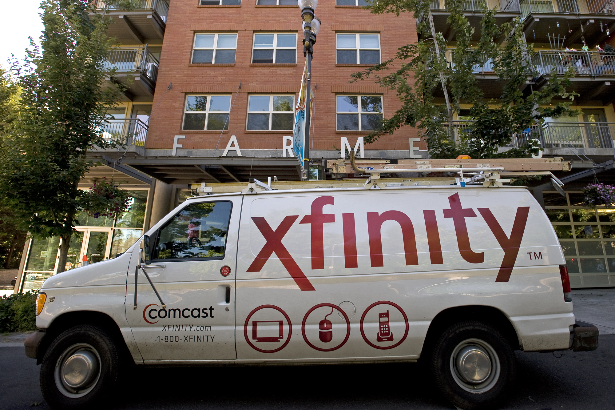 Xfinity truck in front of brick building