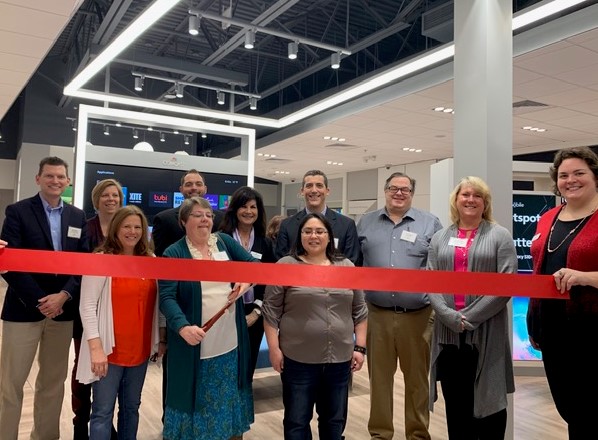 Employees of the XFINITY retail store in Muskegon cut a ribbon at the store's opening.