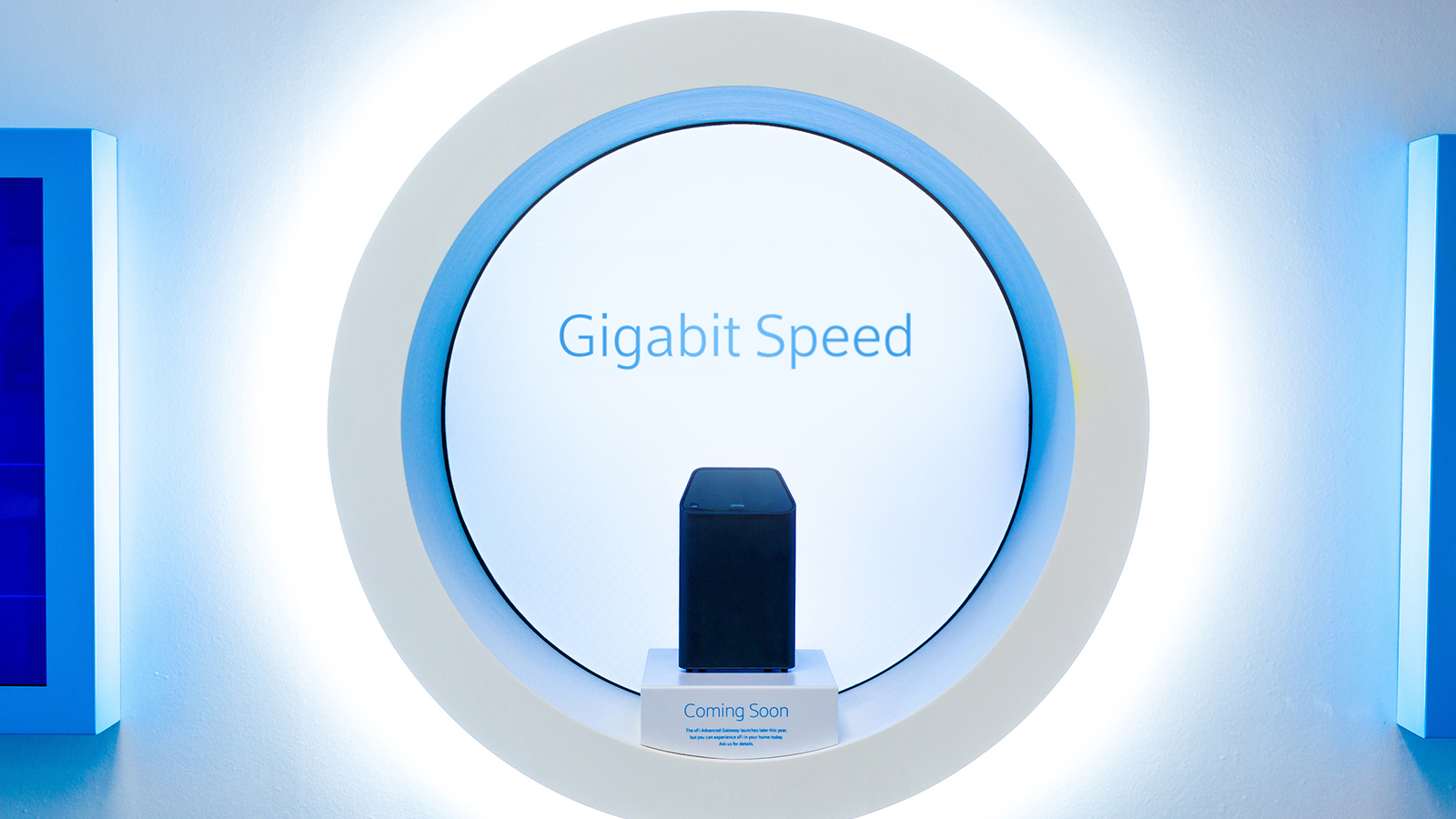 An Xfinity xFi gateway displayed in front of a Gigabit Speed sign.