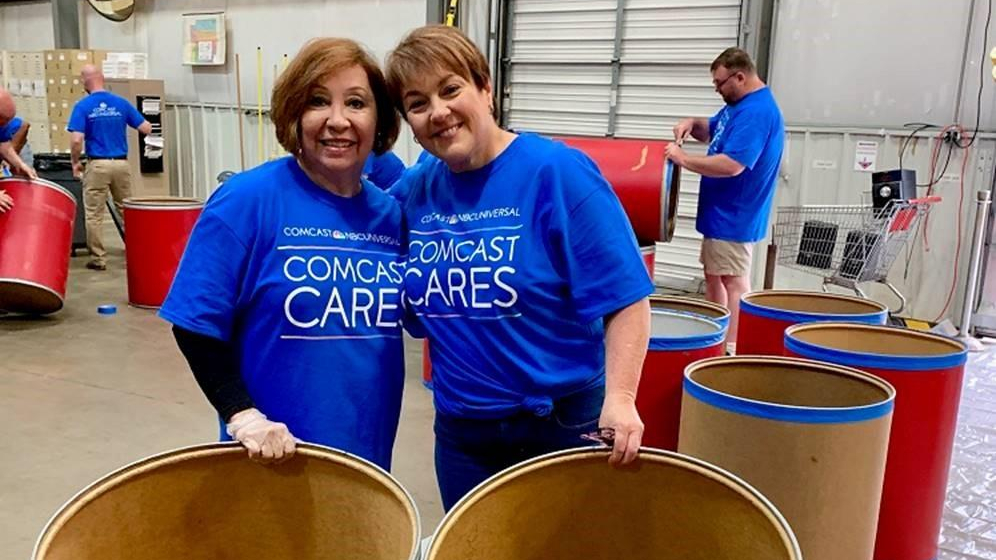 Comcast Cares Day volunteers sort food donations.