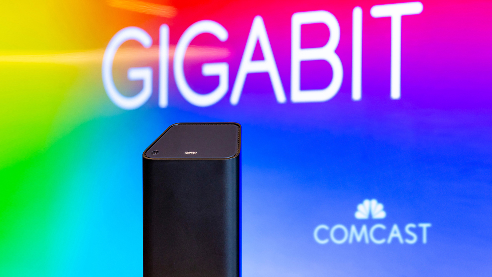 An Xfinity xFi gateway displayed in front of the Comcast logo.