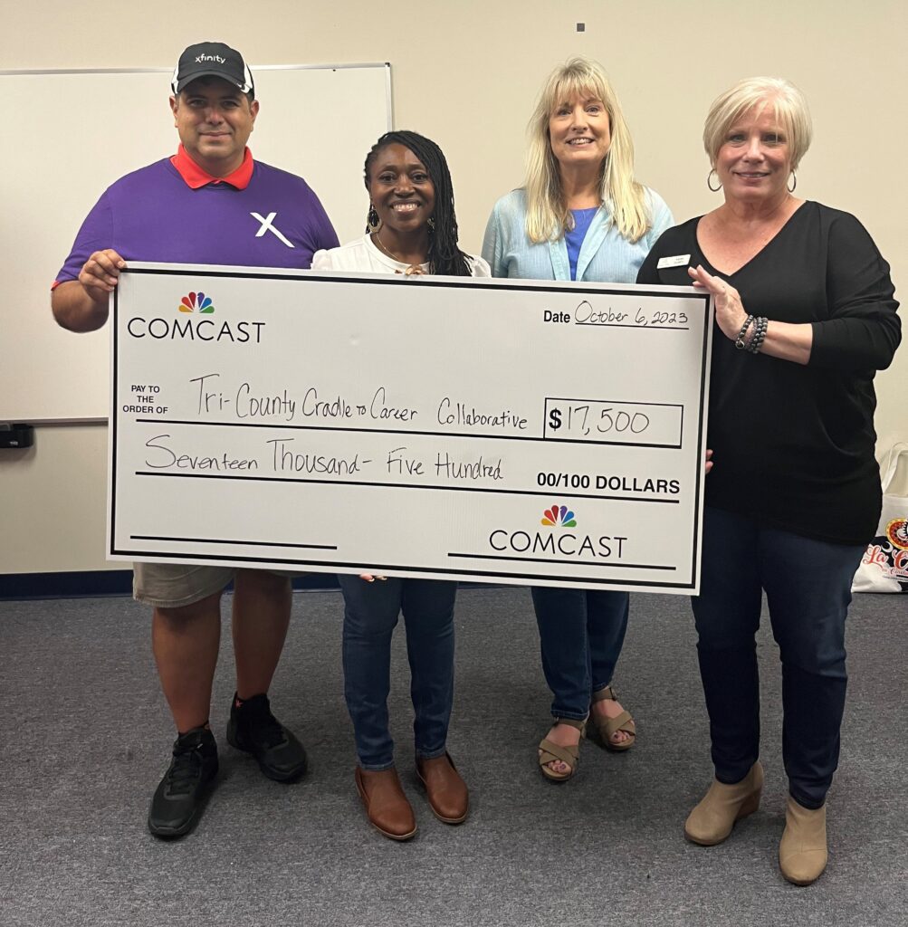 Comcast representatives Lisandro Acosta and Shaneak Brown present Tri-County Cradle to Career Collaborative representatives Stacey Lindbergh and Karen Quadrio with a $17,500 check to advance TCCC’s efforts in educating families living in rural and urban neighborhoods on the importance of broadband adoption in the home.