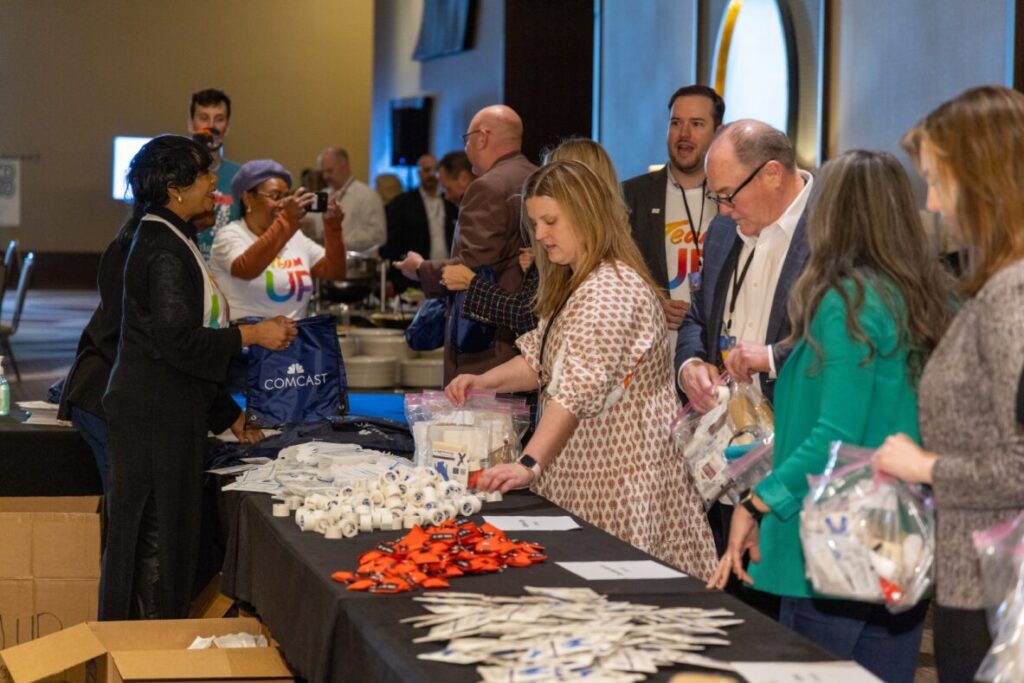 Comcast works with Hands on Nashville for a Team UP volunteer event to create first aid kits to support disaster relief efforts.
