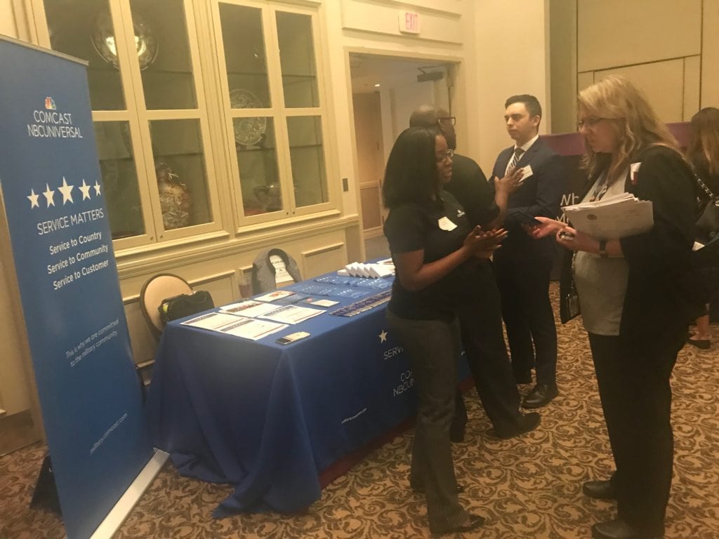 The Comcast NBCUniversal Service Matters booth at a military hiring event.