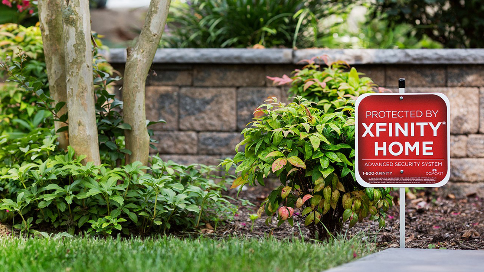 An Xfinity Home sign staked into a lawn.
